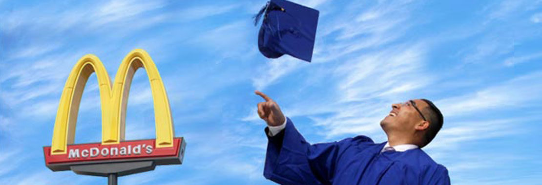 person in gown throwing graduation cap in the air