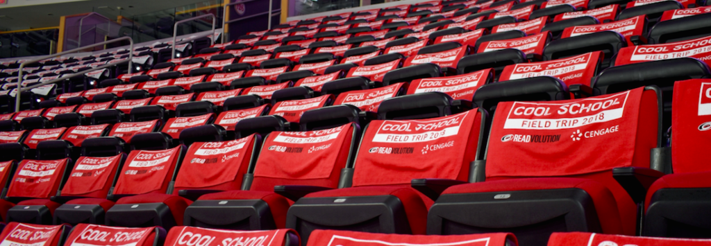 empty stadium seats with red covers that state "Cool School Field Trip 2018" with Cengage logo