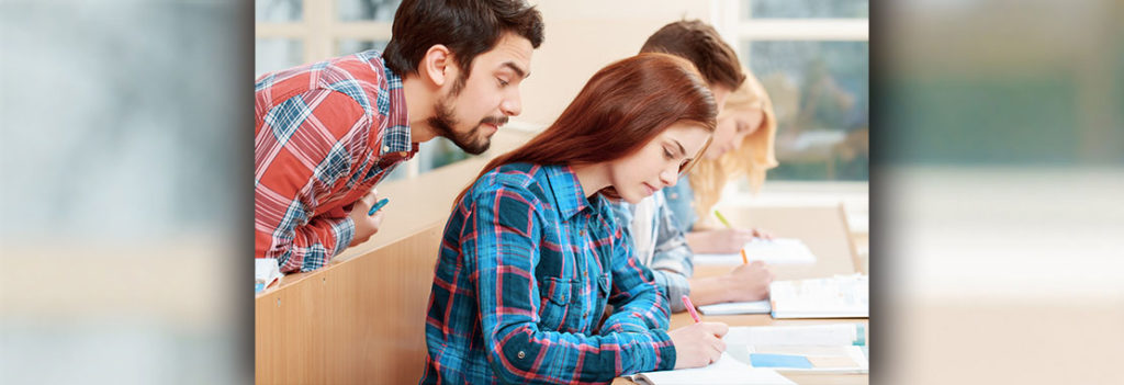 Student looking over the shoulder of another student