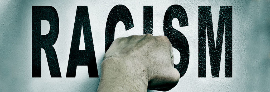 Image of a Fist and the words Racism