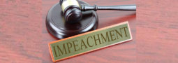 judge's gavel with "impeachment" in name placard