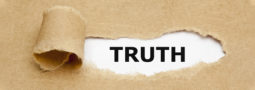 brown paper ripped back revealing the word "truth"