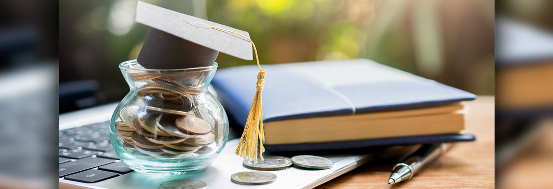 picture of coin jar with graduation cap on top
