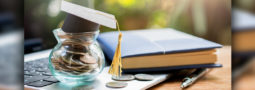 picture of coin jar with graduation cap on top
