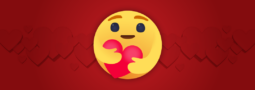 An emoji hugging a heart