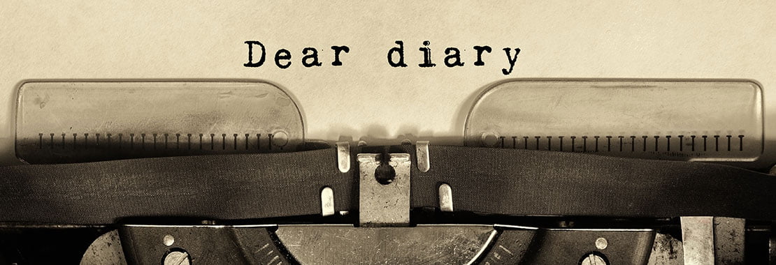 Typewriter with "dear diary" typed out on paper