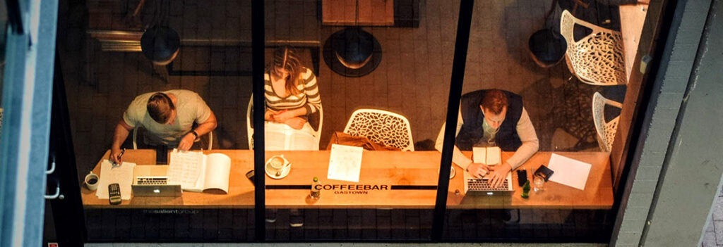 Above view of students studying at a coffee shop