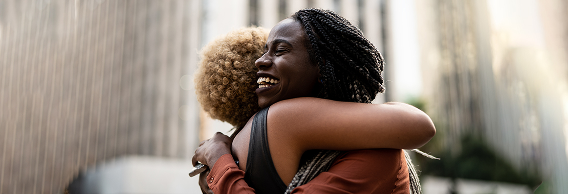 Photo of two women embracing.
