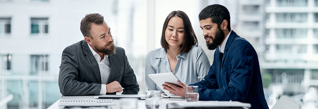 Three instructors review papers together