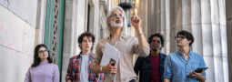 An instructor points up while teaching a group of students