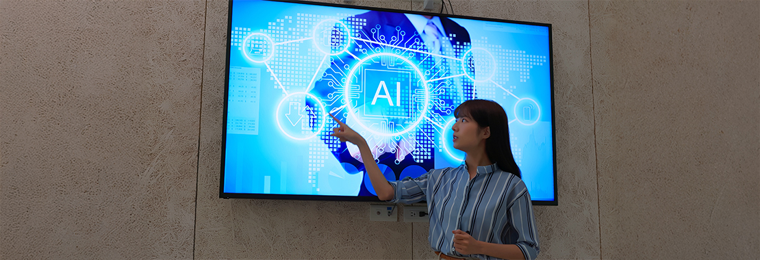 Woman Instructor points to AI presentation on large screen