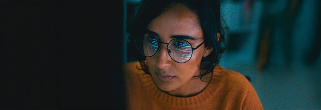 A person stares at a computer screen.